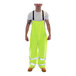 A man wearing Tingley Vision Hi-Vis lime yellow overalls.