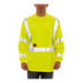 A man wearing a Tingley lime yellow flame-resistant long sleeve safety shirt.