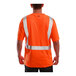 A person wearing a Tingley orange short sleeve safety shirt with reflective stripes.