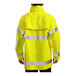 A person wearing a yellow Tingley Comfort-Brite rain jacket with reflective stripes.