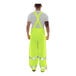 A man wearing Tingley yellow safety overalls with hands on hips.