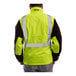 A person wearing a Tingley hi-vis lime and black fleece jacket.