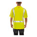 A man wearing a yellow Tingley safety shirt with black front panel and reflective stripes.
