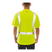 A man wearing a Tingley hi-vis yellow safety shirt with black front panel and reflective stripes.