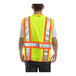 A man wearing a Tingley hi-vis yellow safety vest with reflective stripes.
