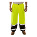 A person wearing Tingley hi-vis yellow pants with black cuffs.