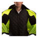 A man wearing a Tingley hi-vis lime and black bomber jacket with black panels.