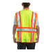 A man wearing a Tingley lime yellow mesh safety vest.