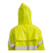 A person wearing a Tingley hi-vis yellow rain jacket with reflective stripes.