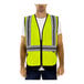 A man wearing a Tingley hi-vis lime safety vest with X-back reflective tape.