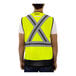 A man wearing a Tingley hi-vis yellow safety vest with X-back reflective tape.