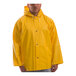 A man wearing a Tingley yellow industrial rain jacket with a hood.