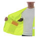 A man wearing a Tingley lime yellow safety vest.