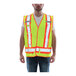 A man wearing a Tingley Hi-Vis lime yellow safety vest with reflective X on the back.