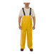 A man wearing yellow Tingley Weather-Tuff rain overalls.