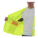 A man wearing a Tingley lime yellow safety vest with an orange pocket.