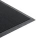 A close-up of a black Cactus Mat rubber entrance mat with holes in it.