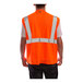 A person wearing a Tingley hi-vis orange safety vest with reflective stripes.