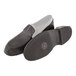 A pair of Tingley black rubber overshoes over black shoes.