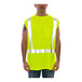 A man wearing a Tingley lime green sleeveless shirt and yellow safety vest.