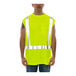 A man wearing a Tingley lime green hi-vis sleeveless shirt over a yellow safety vest.