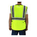 A person wearing a Tingley lime yellow safety vest.