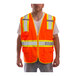 A man wearing a Tingley hi-vis orange safety vest with reflective stripes.