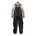 A man wearing Tingley black insulated overalls.