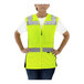 A woman wearing a Tingley lime yellow mesh safety vest.