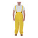 A man wearing yellow Tingley Industrial Work rain overalls.