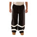 A person wearing Tingley Icon black pants with reflective tape on the legs.