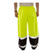 A person wearing Tingley Hi-Vis lime pants with black cuffs and a reflective vest.