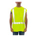 A man wearing a Tingley lime green sleeveless shirt over a yellow safety vest.