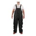 A man wearing Tingley black insulated overalls over a white shirt.