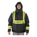 A man wearing a Tingley black insulated jacket with reflective stripes.