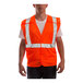 A man wearing a Tingley hi-vis orange safety vest with reflective stripes.