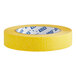 A close-up of a roll of yellow Lavex masking tape.