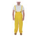 A man wearing yellow Tingley Industrial Work overalls.