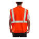 An orange Tingley Job Sight safety vest with reflective stripes.