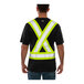 A back view of a man wearing a black Tingley safety shirt with yellow reflective X-back tape.