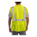 A man wearing a Tingley high visibility lime mesh safety vest.