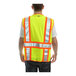 A man wearing a Tingley yellow safety vest with reflective stripes.