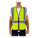 A man wearing a Tingley high visibility yellow mesh safety vest with reflective tape.