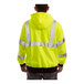 A person wearing a Tingley hi-vis lime sweatshirt over a yellow safety jacket.