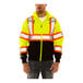 A man wearing a yellow and black Tingley Job Sight zip-up sweatshirt with reflective tape.