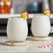 Two glasses of white Frose Blanc with fruit garnishes.