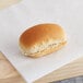 A Vienna Beef mini hot dog roll on a piece of paper.