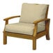 A Three Birds Casual Monterey sand wooden arm chair with beige cushions.