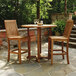 A Three Birds Casual Monterey outdoor bar chair on a stone patio table with another chair.