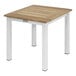 A Three Birds Casual teak coffee table with a wood top and white base.